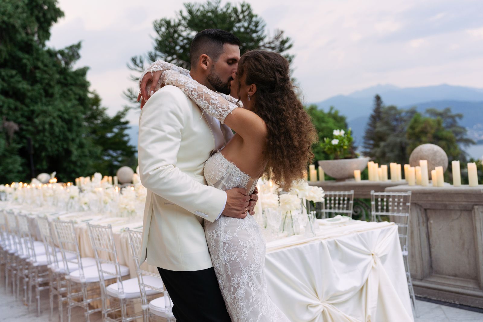 destination-wedding-lake26 Bride and groom kissing at their wedding reception at Villa Muggia overlooking Lake Maggiore