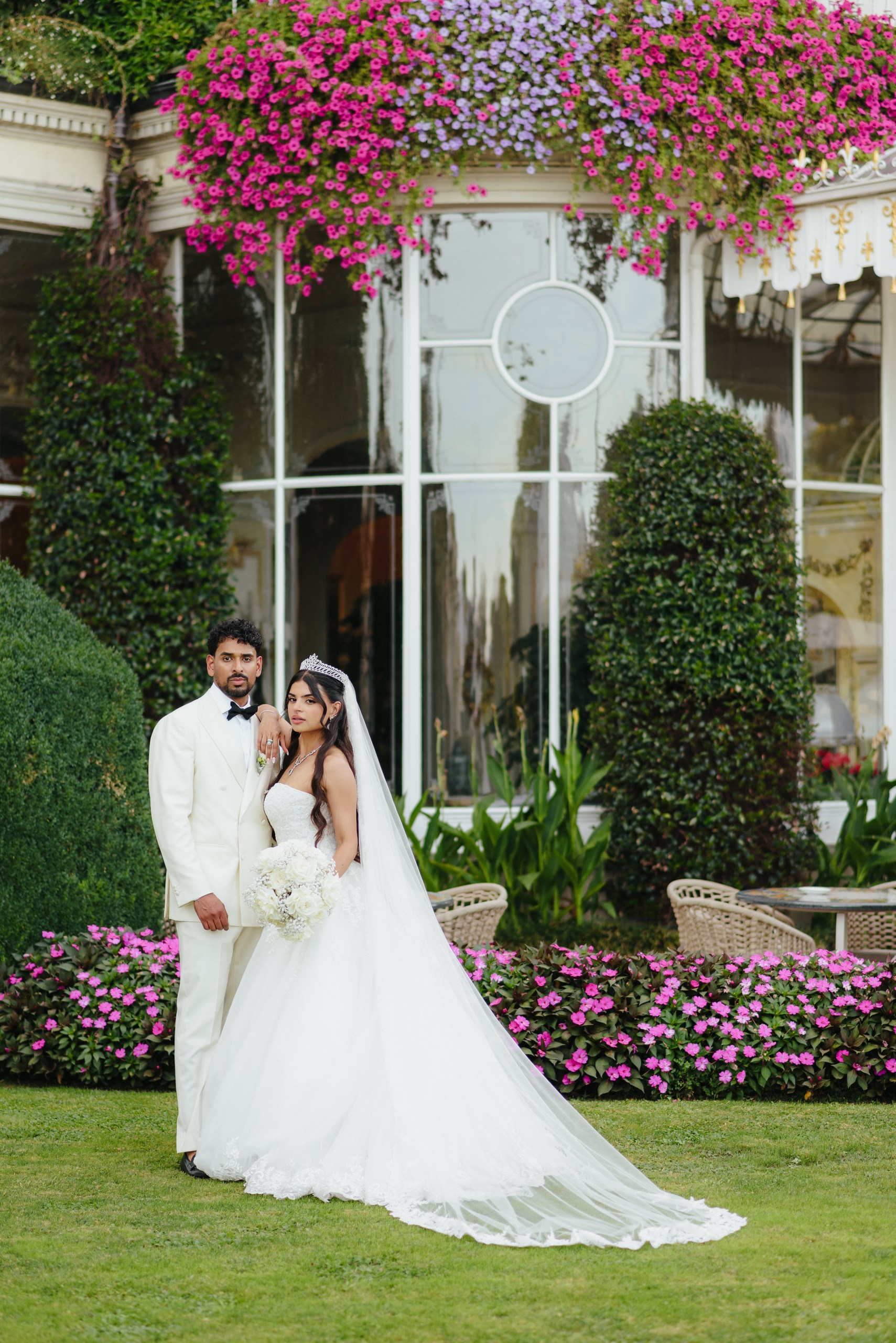Romantic Wedding Portrait – Andrea & Max Bride and groom holding hands in a romantic garden with pink flowers in Stresa, Italy.