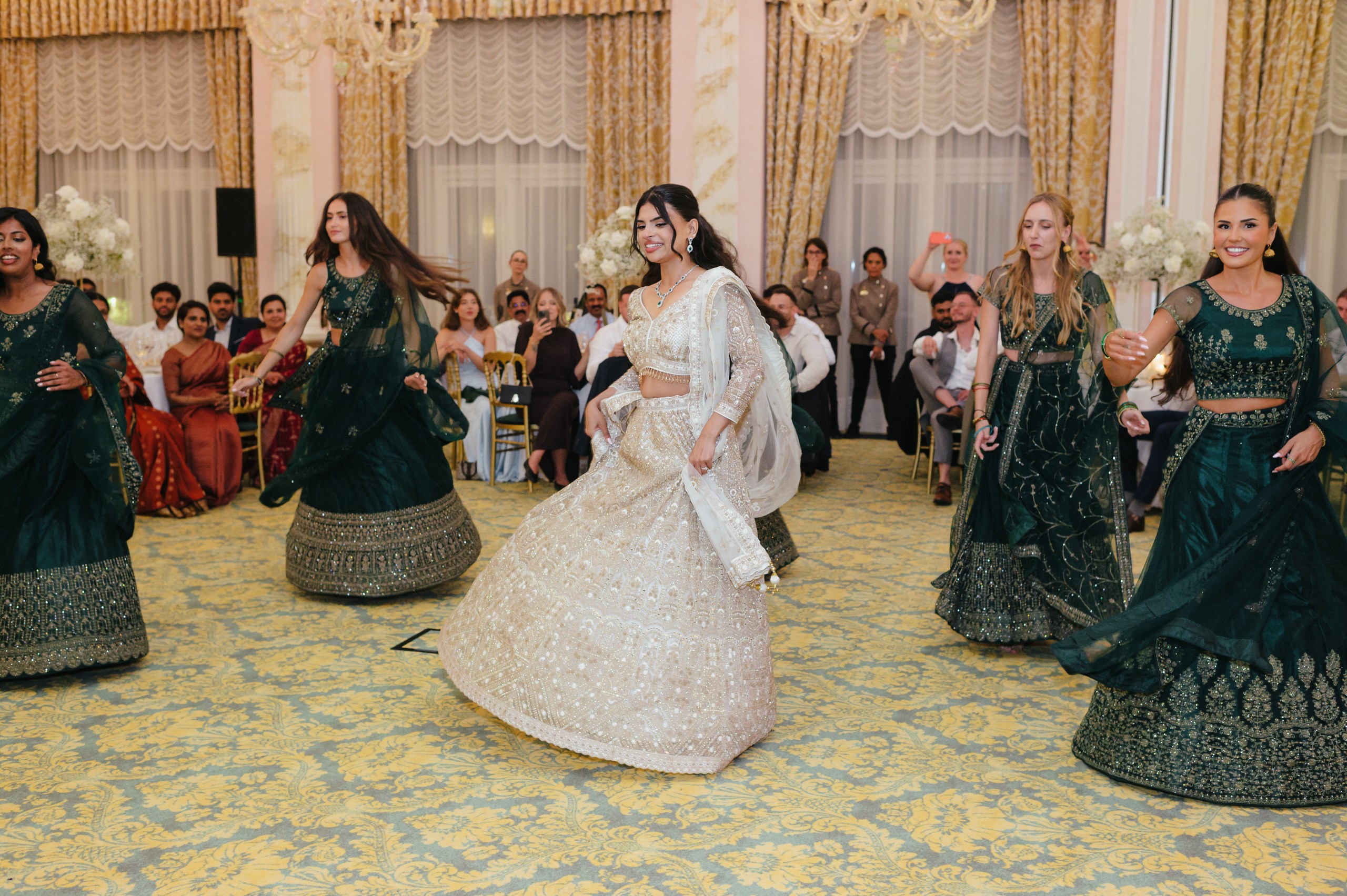 Indian Wedding Dance | Andrea & Max – Lake Maggiore Bride dancing with her bridesmaids in traditional Indian outfits during a multicultural wedding celebration on Lake Maggiore, Italy.