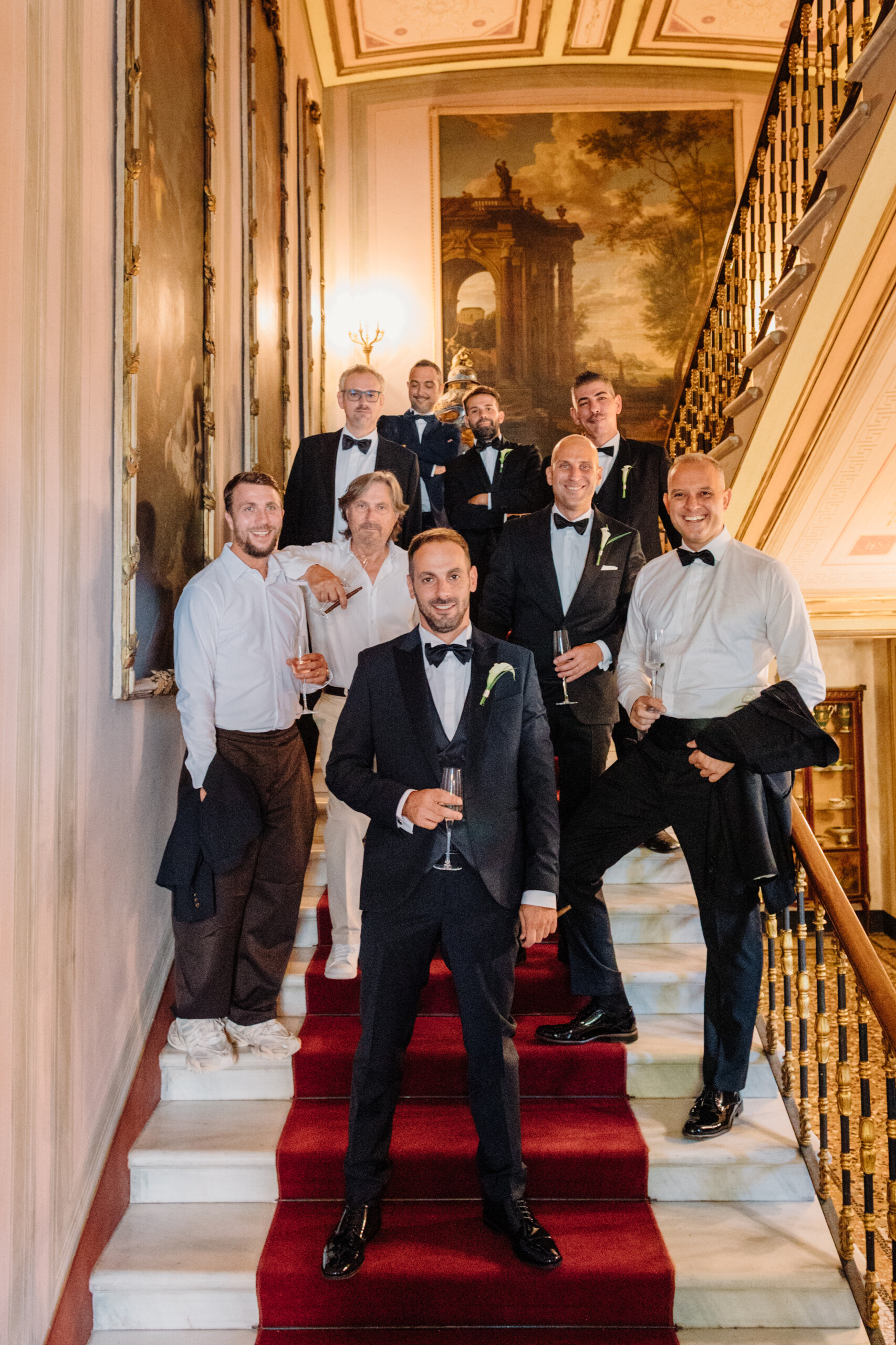 Groom and Friends – Villa Cimena Wedding in Turin Groom Enrico posing with his friends on the historic staircase inside Villa Cimena during his wedding day.