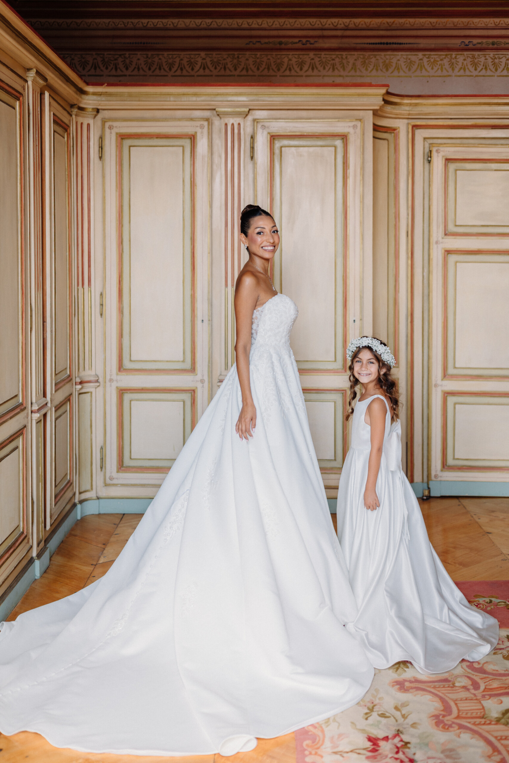 Bride and Flower Girl – Villa Cimena Wedding in Turin Bride Giannella in a white wedding gown with a young flower girl wearing a floral crown inside Villa Cimena in Turin, Italy.