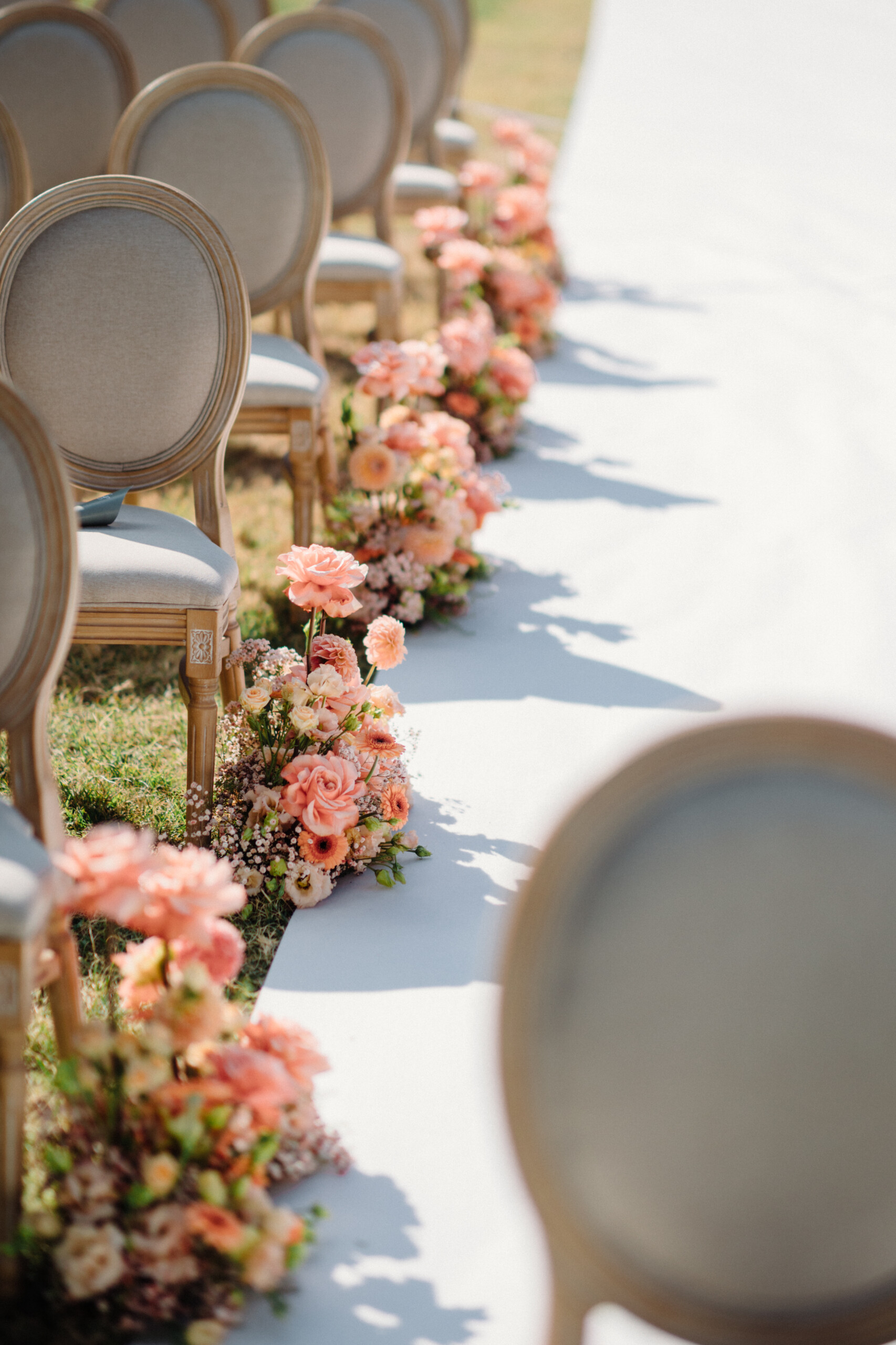 Wedding Ceremony Flowers – Villa Cimena in Turin Pink and peach floral arrangements decorating the outdoor wedding ceremony aisle in the gardens of Villa Cimena.